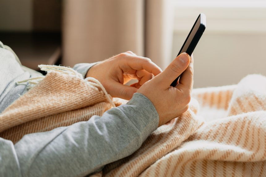 Teacher scrolling through Edutwitter on his smartphone