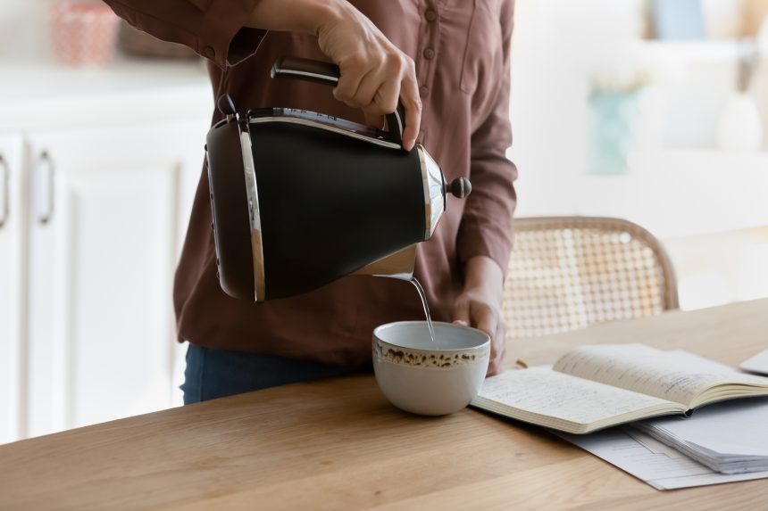 Female student pouring a cup of coffee whilst taking a revision break.