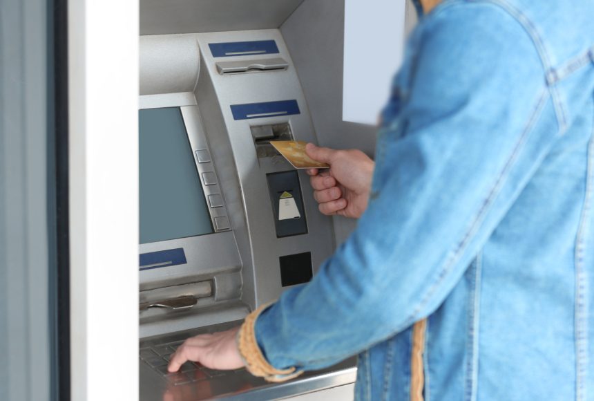 Student withdrawing money from a cash machine.