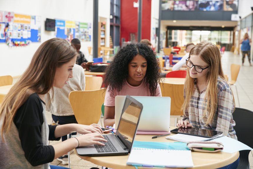 Three female sixth form students working during their free period.