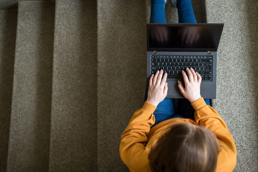 Student researching UCAS Clearing places on a laptop.