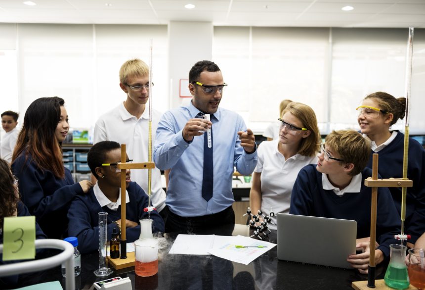 A diverse group of school students in a science classroom.