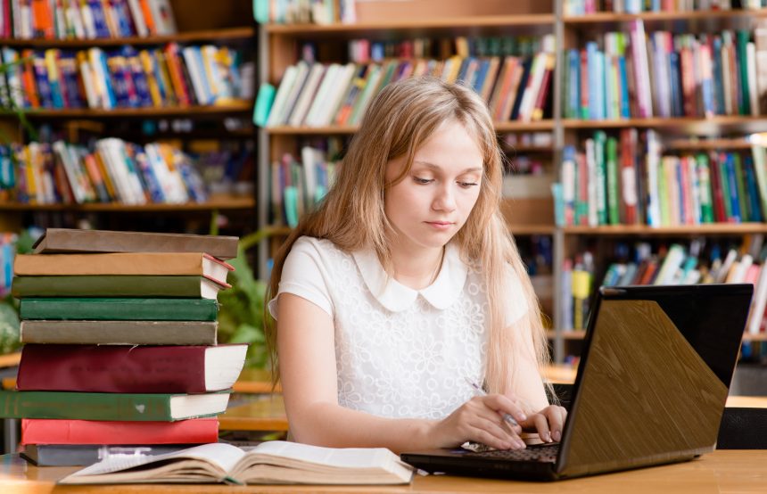 Female student studying in her local library.