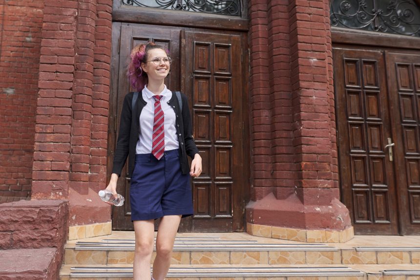 A high-achieving female student walking to school.