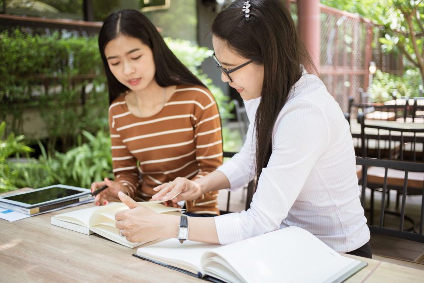 A girl learning by teaching her mother.