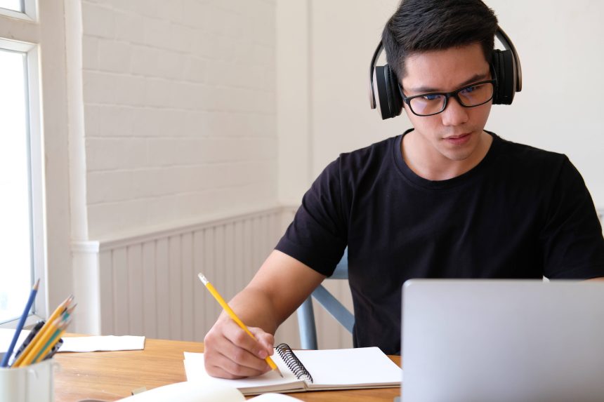 A student listening to audio feedback left by his teacher.