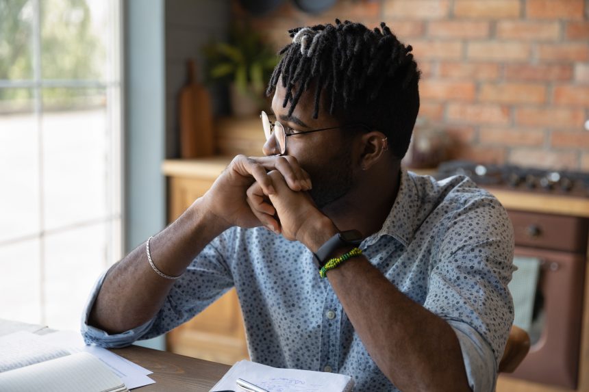 A male student thinking about whether he should take the UCAT or BMAT.