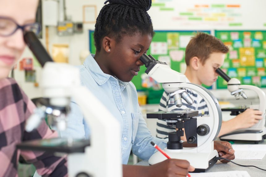 Pupils looking down microscopes during biology practical.