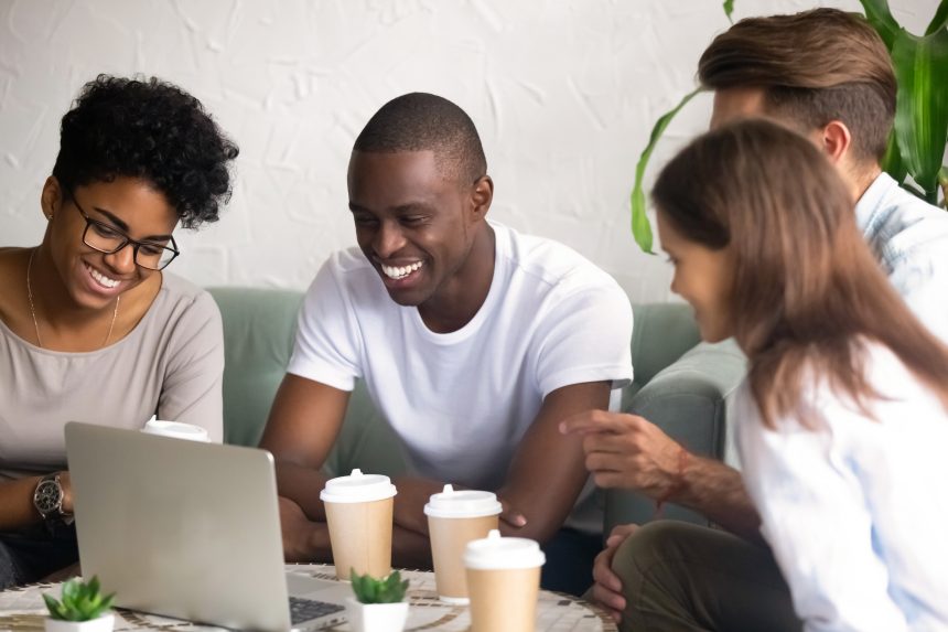 A group of co-workers smiling and chatting.