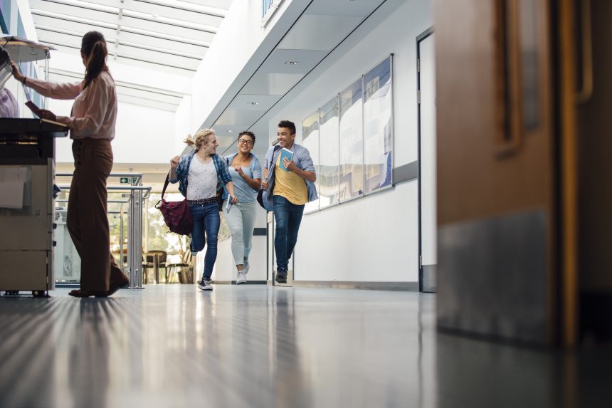 Students running down the corridor on their last day of school.