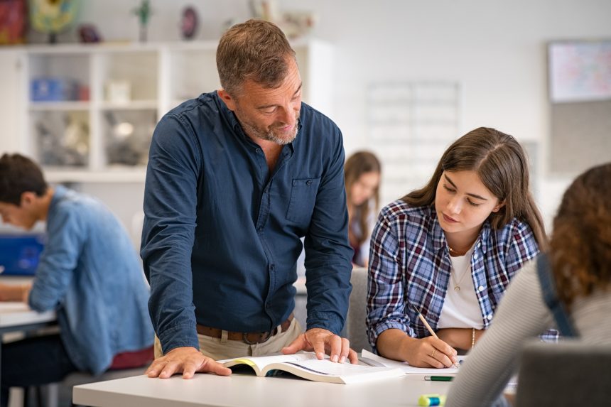 Male teacher helping female student prepare for the MAT exam.