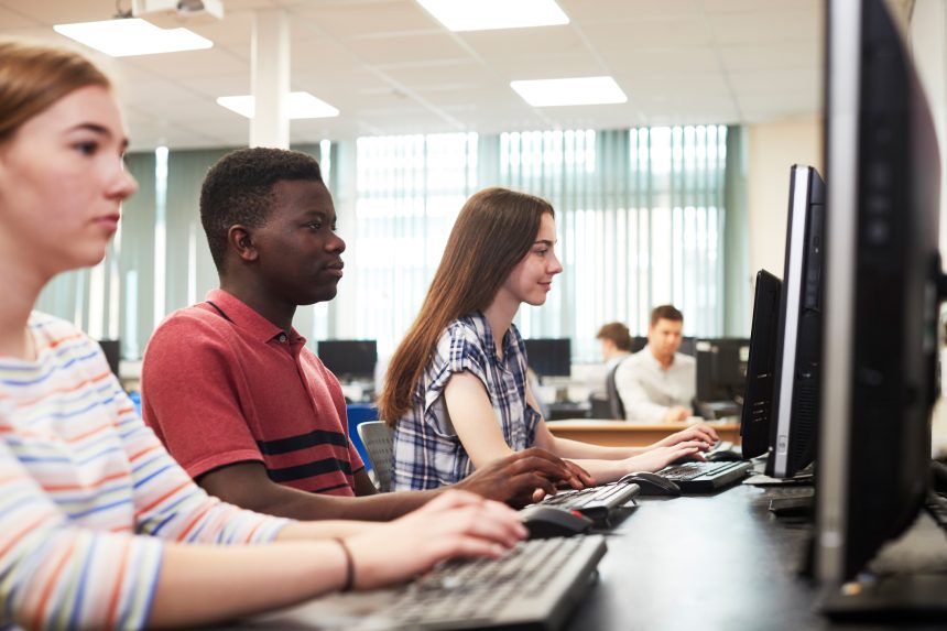 Three students using computers to research post-16 options.