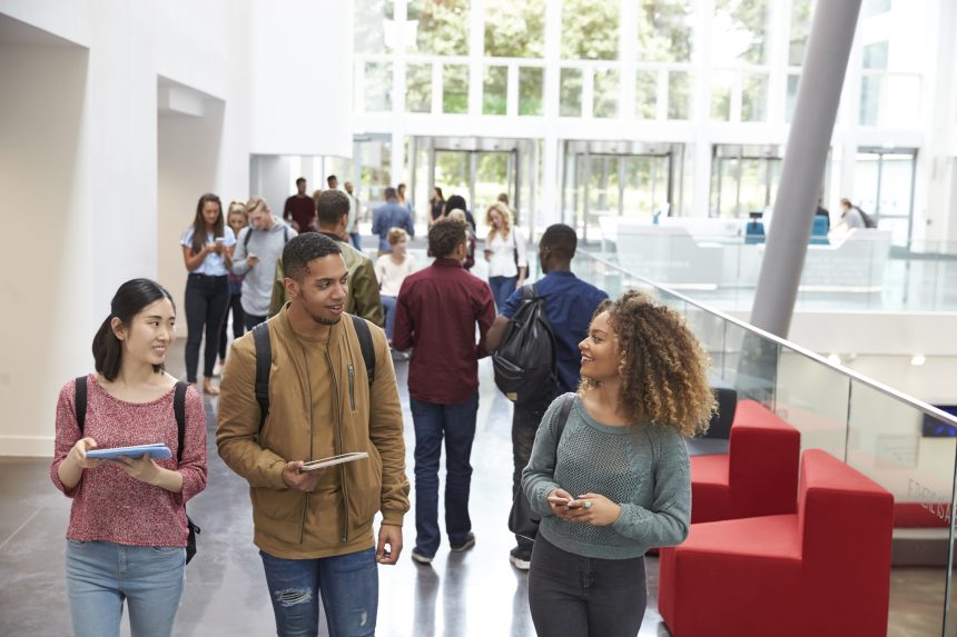 Prospective students walking down the lobby of a university during its open day.