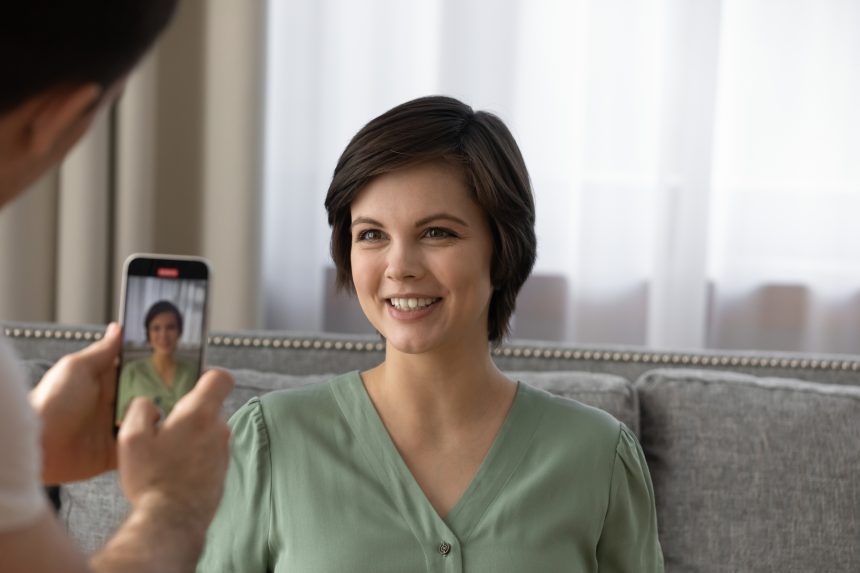 A female tutor get her headshot taking on a smartphone.