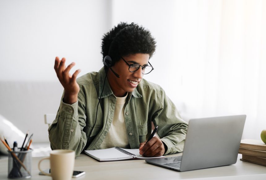 Online tutor talking to his student on a laptop.