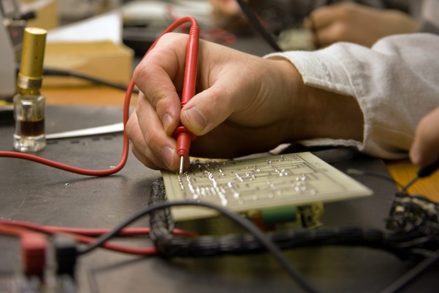 A Level Product Design student soldering.