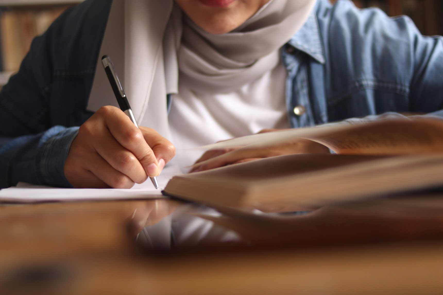 Female student practising her creative writing skills.