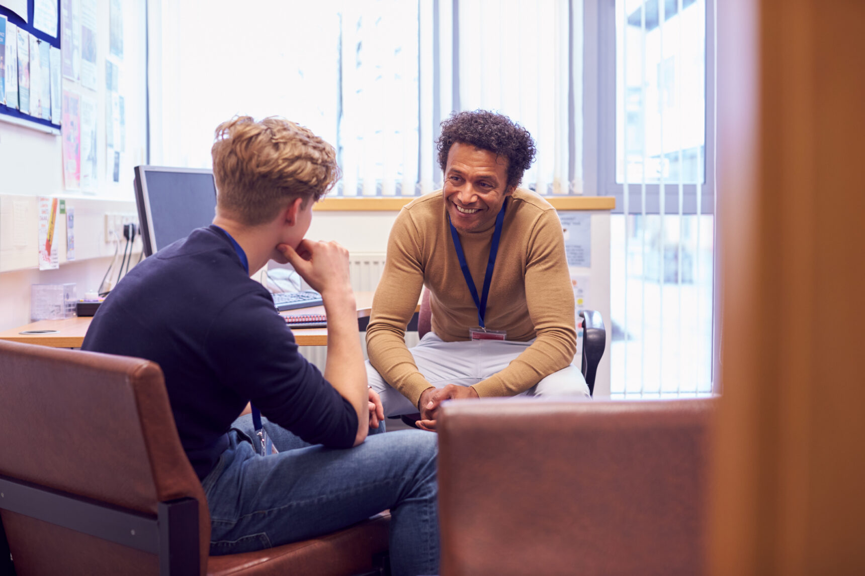 Student meeting with his teacher in a school office to discuss whether a GCSE remark would be worthwhile.