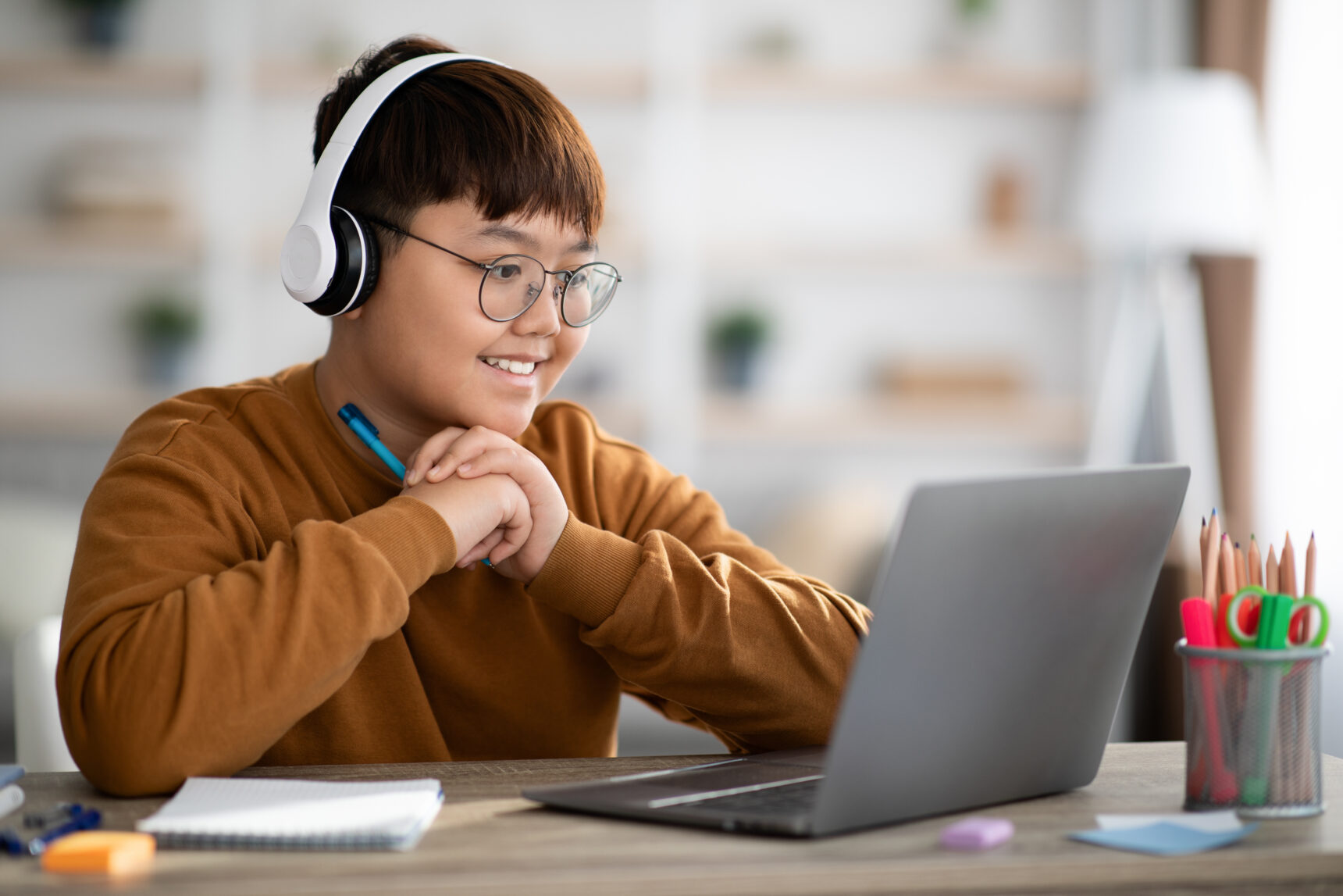 A male student taking part in an maths online tutoring session.