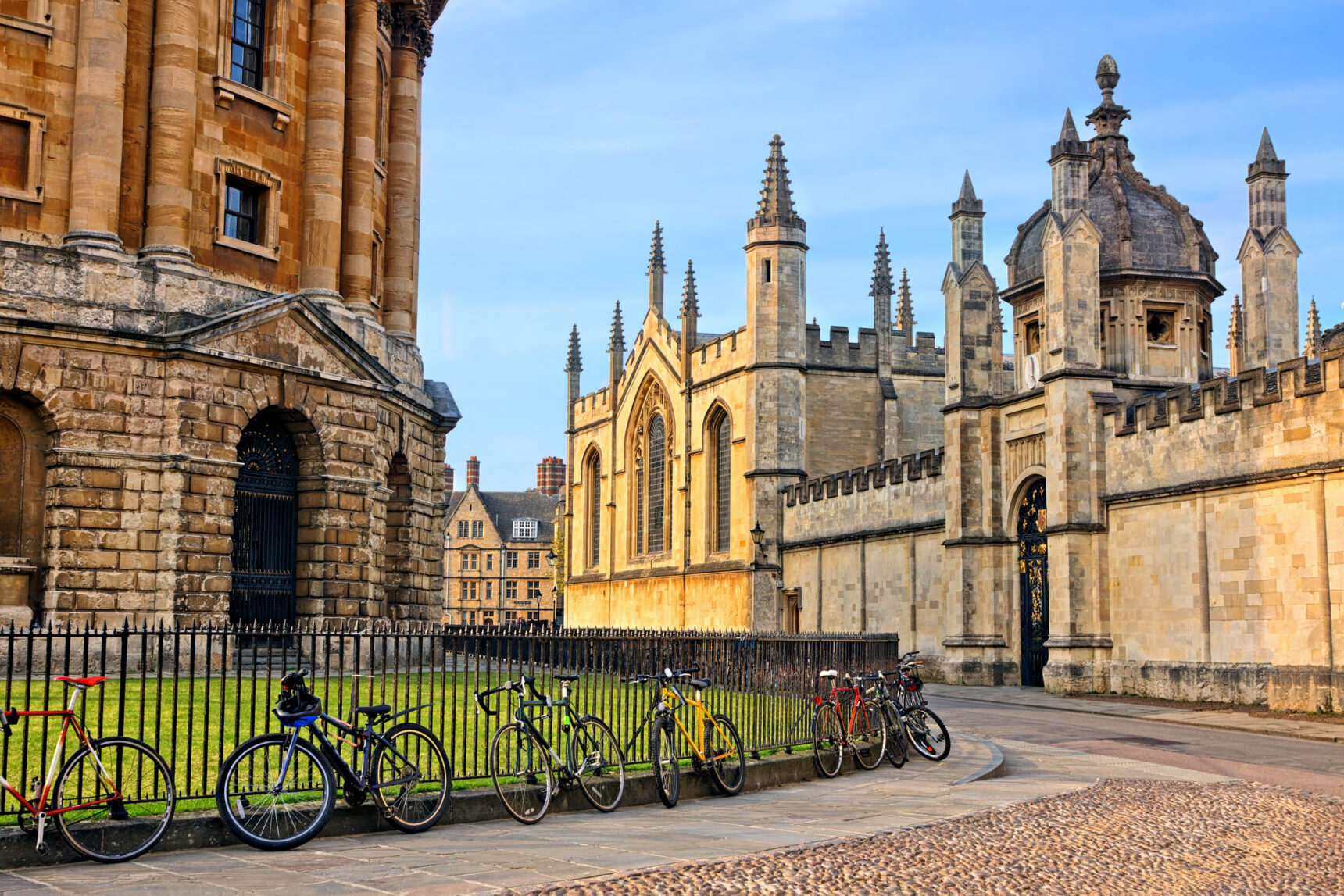 Bicycles tied to railings outside an Oxford University building.