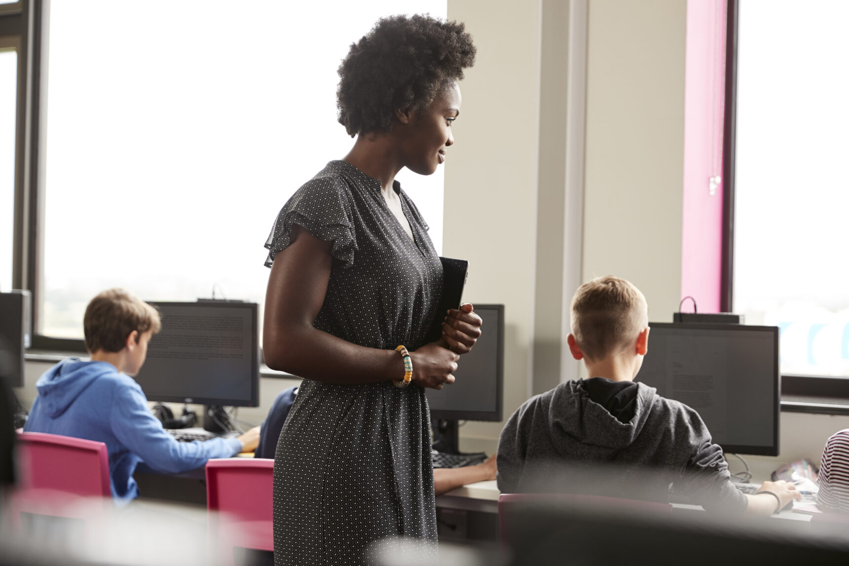 Teacher supervising students in the classroom.
