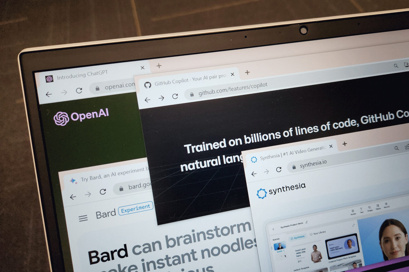 A computer screen showing several AI programmes including OpenAI, Bard, GitHub Copilot, and Synthesia.