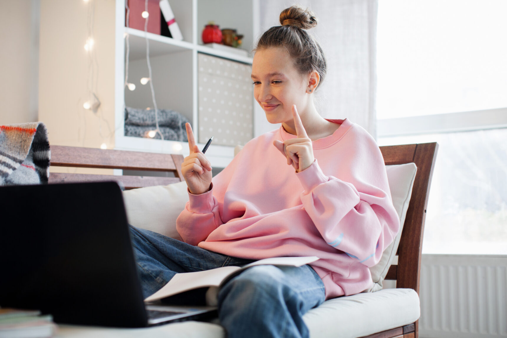An autistic student smiling during an online tutoring session.