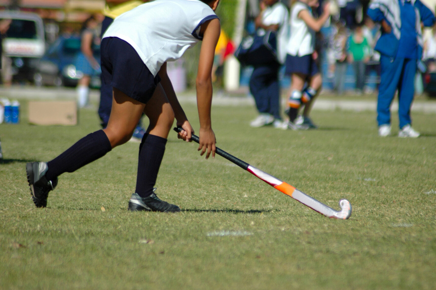 GCSE student playing hockey with a school team.