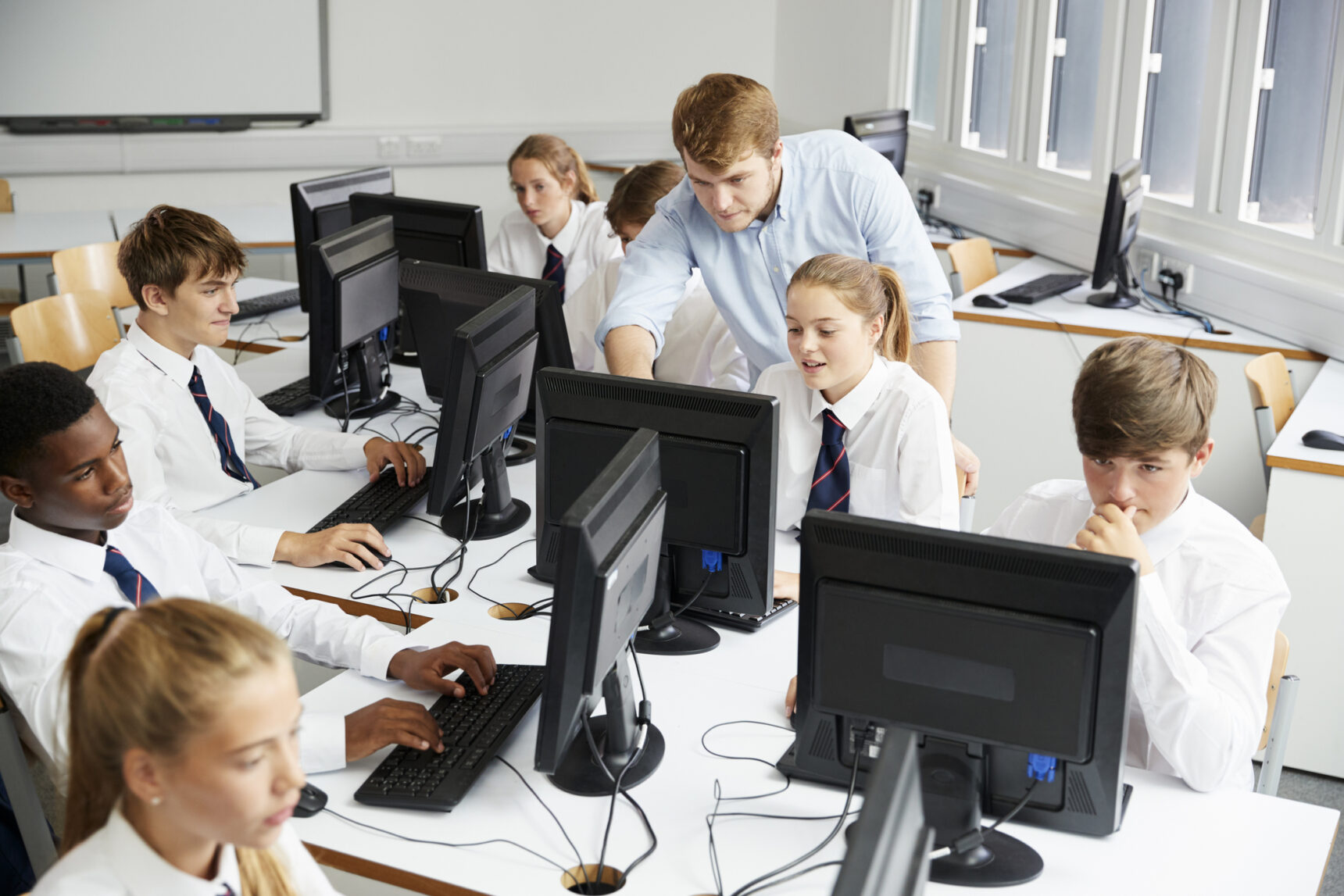 Teacher teaching a group of students in a GCSE Computer Science class.