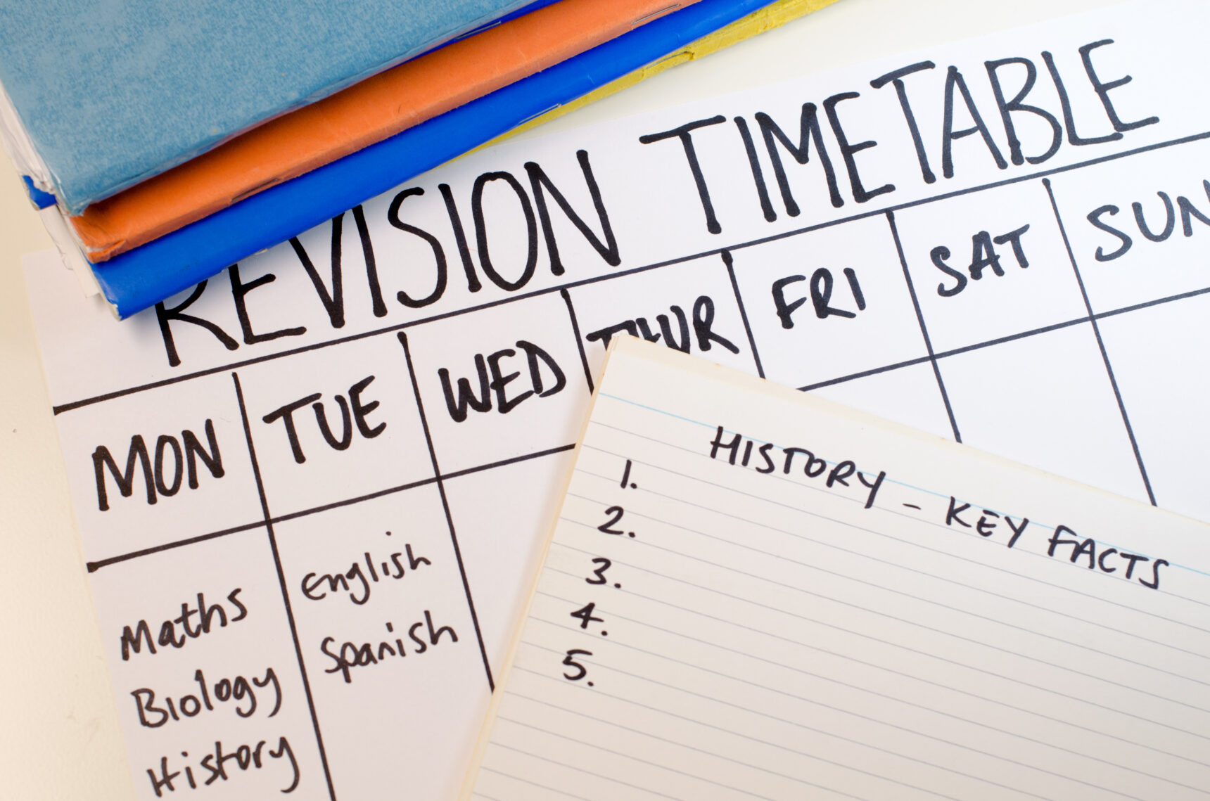 A weekly revision timetable for GCSE exams and a history "key facts" flashcard.