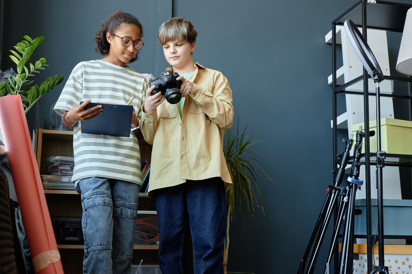 Two home educated teenagers are working on a creative photography project.