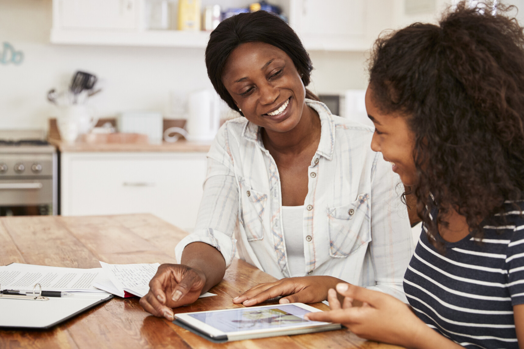 A mother and her home-educated daughter are sitting in the kitchen discussing what GCSEs to study.